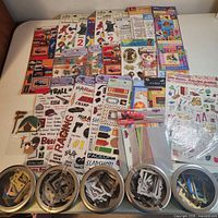 Overview of all sticker packages and five chipboard tins