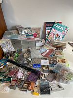Overall view of crafting supplies, paper pads, chipboard, magazines and storage chest
