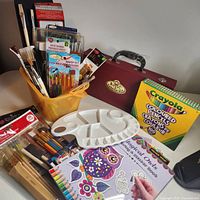 Overview of coloured pencils box, Royal & Langnickel case, palette, brush sets, loose brushes and books