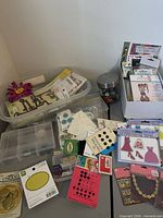 Overall lot showing buttons, snaps, brads, stickers, storage containers