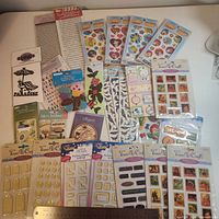 Overview of all 27 sealed sticker packs on table