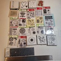 All 25 stamp sets arranged with ruler for scale