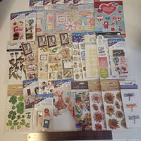 Wide view of multiple unopened sticker packs with ruler for scale