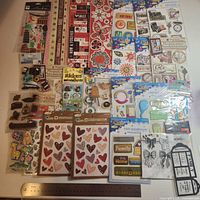 Overview of approximately 25 sealed sticker packs laid out
