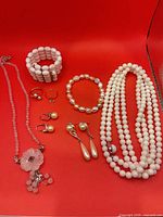 Group shot of all jewelry pieces on red background