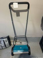 Full view of Yardworks reel mower standing upright