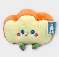 Front view of toast plush showing face, colors, attached tag