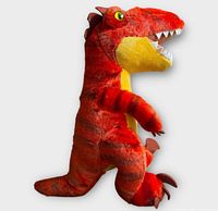 Left side profile of red velociraptor plush showing coloration, eyes, teeth, limbs