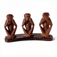 Front view of the carved wood three-monkey sculpture