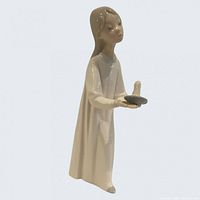 Front view of porcelain girl holding candle