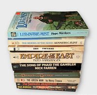 Stack of ten fantasy paperbacks showing spines and top cover