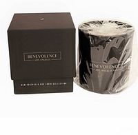 Candle beside its branded box showing label and packaging