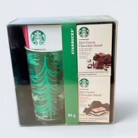 Front view of sealed Starbucks mug gift set showing mug and cocoa packets