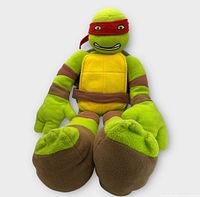 Front view of Raphael plush showing full body and facial details