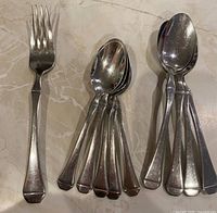 All 10 flatware pieces laid out
