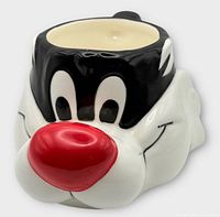 Front view of sculpted Sylvester mug showing face and red nose