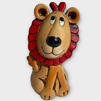 Front view of chalkware lion coin bank