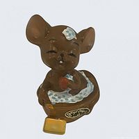 Front view of ceramic mouse figurine showing label and bubbles