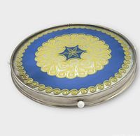 Top view showing blue mirrored glass with yellow floral starburst design and chrome rim