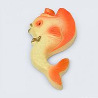 Front view of cream and orange chalkware fish plaque with gold bowtie