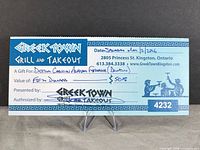 Front view of the $50 Greek Town Grill gift certificate on stand