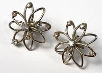 Front view of both floral diamond stud earrings