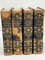 Spine view of all four volumes showing titles and damage