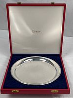 Tray inside open red Cartier case showing branding and overall condition