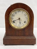 Front view of clock showing oak case and dial