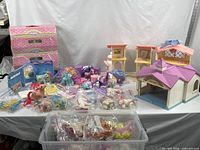 Wide shot of entire lot showing carry cases, playsets, ponies and accessories