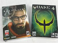 Half-Life 2 and Quake 4 retail PC game boxes side by side