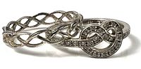 Both rings together showing knot and braided designs