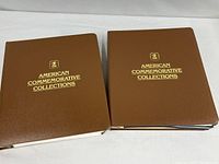 Two brown vinyl binders with gold lettering
