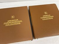 Front view of two brown USPS American Commemorative Collections binders