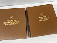 Front covers of two brown vinyl American Commemorative Collections binders