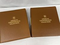 Two brown vinyl USPS American Commemorative binders closed