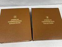 Two closed brown vinyl binders with gold-foil American Commemorative Collections titles