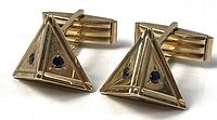 Pair of gold pyramid cufflinks front view showing sapphire stones