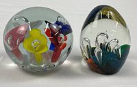 Both paperweights side by side showing overall shapes and colors