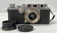 Front view of Leica III camera with lens, cap, hood