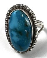 front view of sterling silver ring with turquoise cabochon and beaded bezel