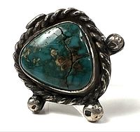 Front view showing turquoise stone, cracks, rope bezel, ball accents