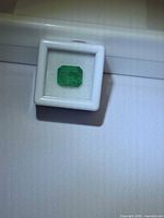 Emerald in presentation box showing octagon cut and colour