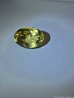 Top view of faceted lemon citrine on white background