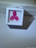 Three oval cut rubies in display box