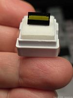 Front view of rectangular green tourmaline on gem box