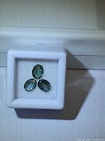 Three oval sapphires in gem box
