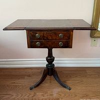 Front view showing table with leaves down, drawers, pedestal, legs