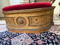 full view of front showing gilt carvings and red velvet seat