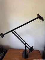 Full view of Artemide Tizio lamp on table showing overall form